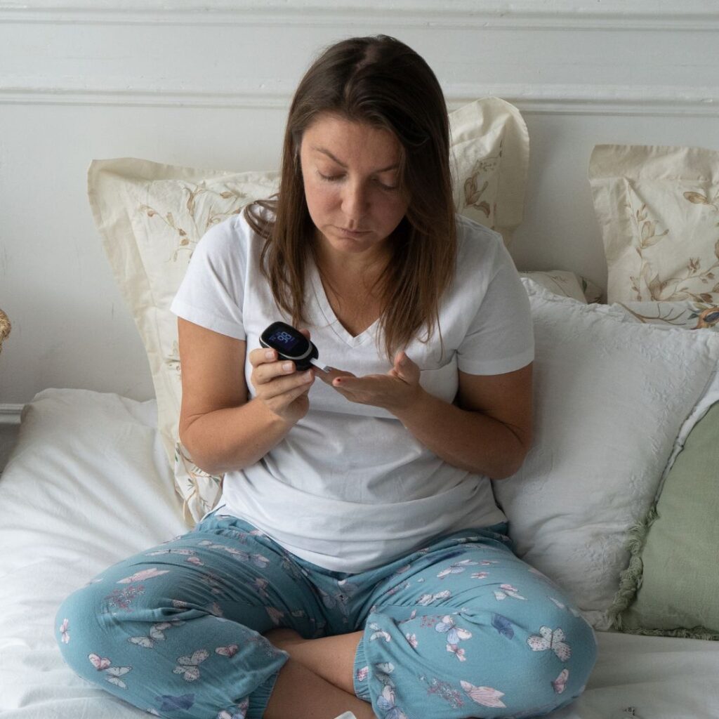 Woman testing blood sugar