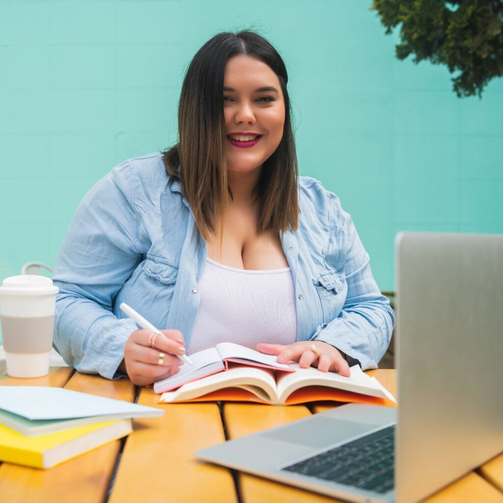 Woman at computer taking notes