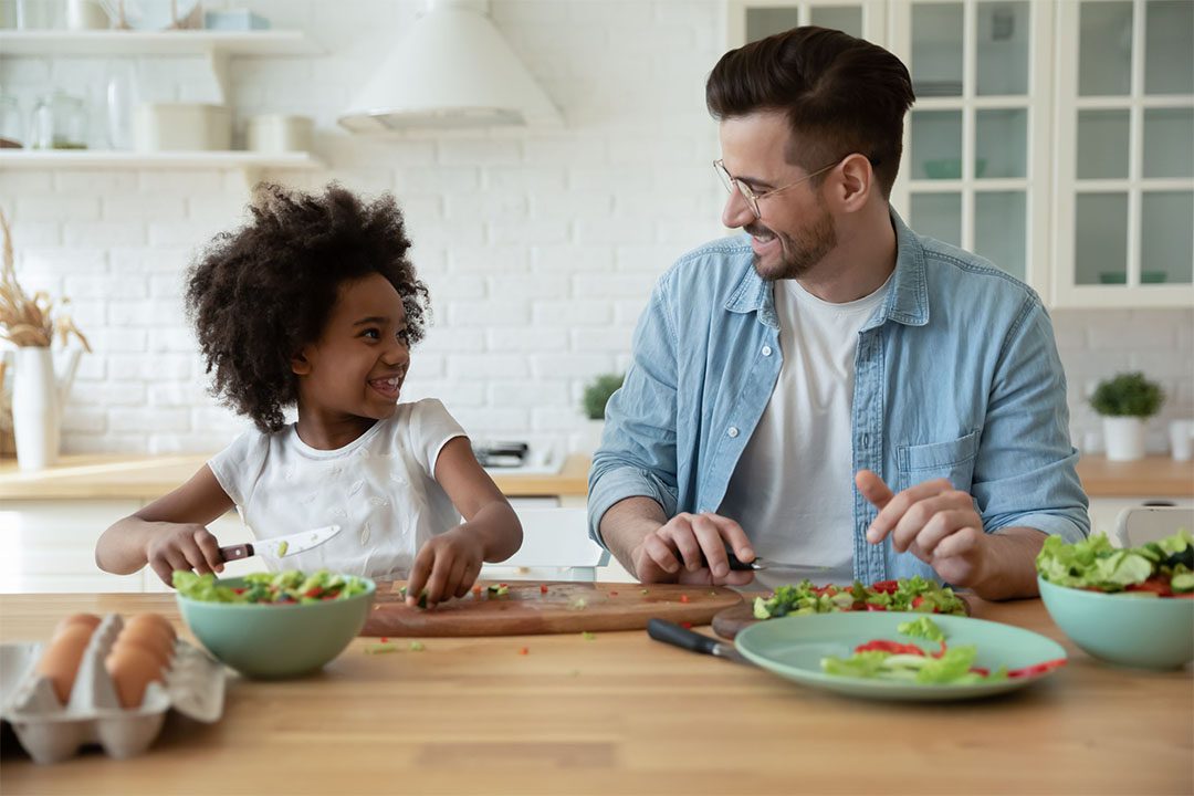 man with daughter eating healthy foods